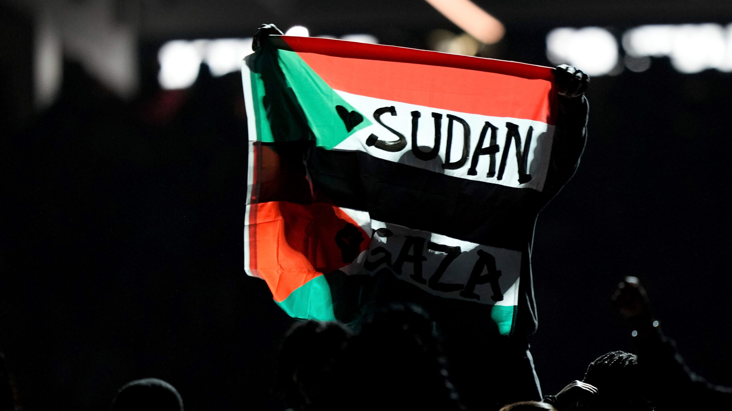 Super Bowl show interrupted by Sudanese-Palestinian flag protest